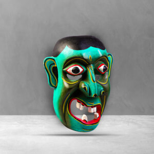 Side view of a traditional Sri Lankan Kolam Mask showing intricate design and carving.