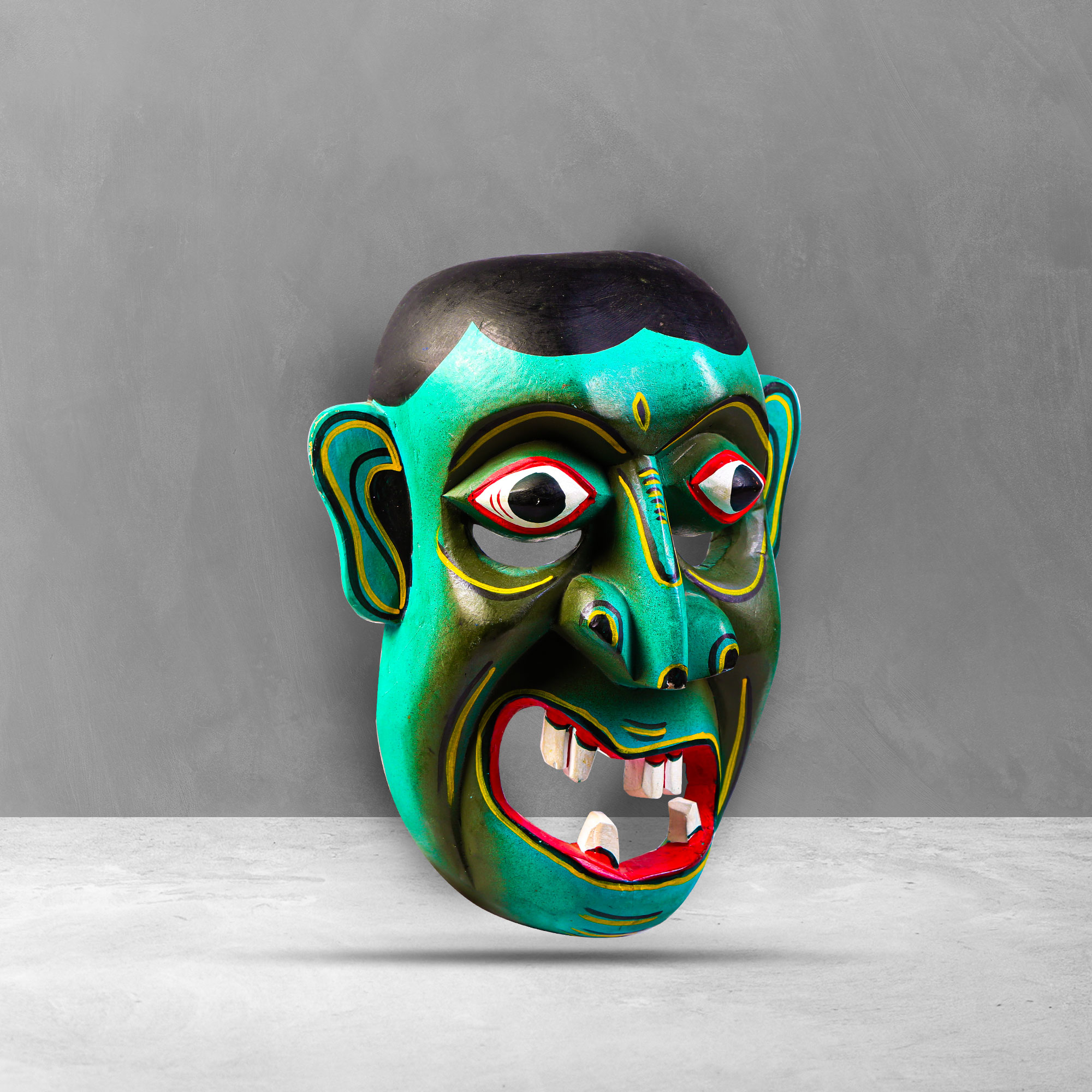 Side view of a traditional Sri Lankan Kolam Mask showing intricate design and carving.